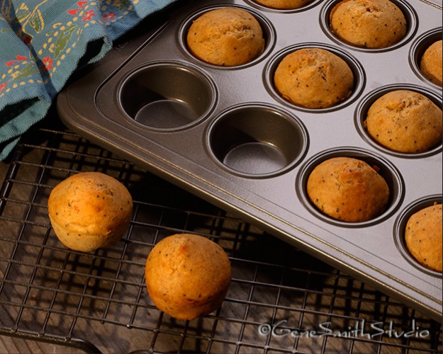 Hot muffins straight from the oven cool in their pan on a wire rack.