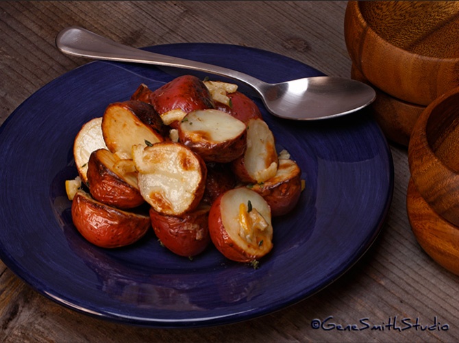 Roasted baby red potatoes on navy blue plate