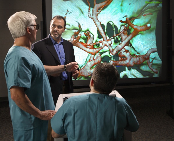 Doctors and surgeons look at display of three-dimensional Cat Scans with Dextrobeam equipment