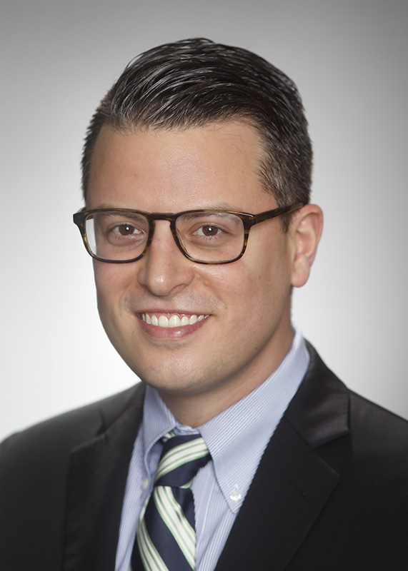 Young male attorney corporate portrait by Gene Smith for Gene Smith Studio on location with studio lighting and background.