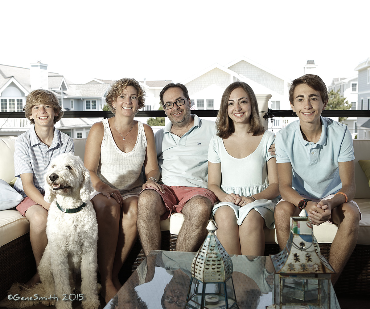 Five family members and their dog relaxing on balcony of new beach house in Avalon, NJ