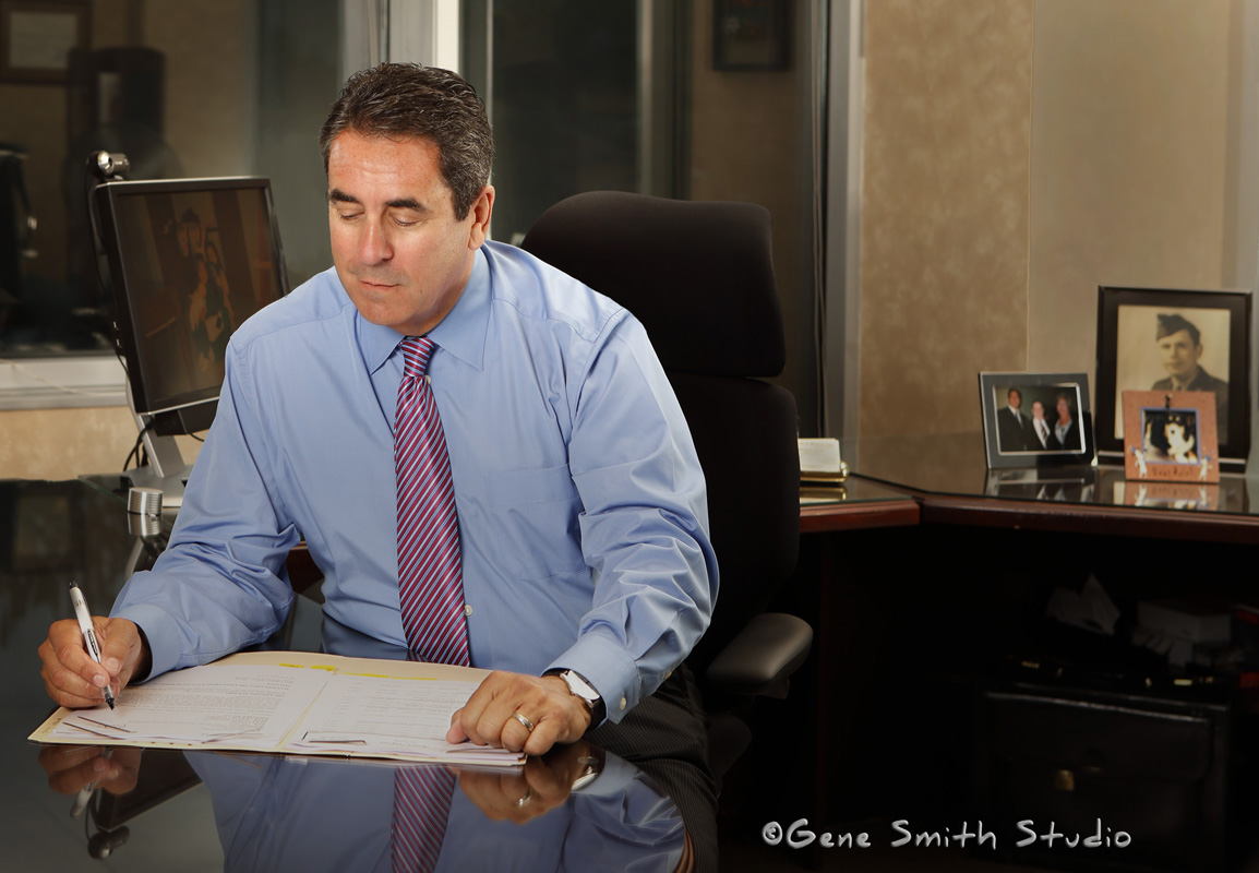 Attorney in shirtsleeves working in the evening at his desk in Voorhees, NJ photographed by Gene Smith for attorney's professional website. More than just a headshot this environmental portrait tells a story about the subject and what he does.