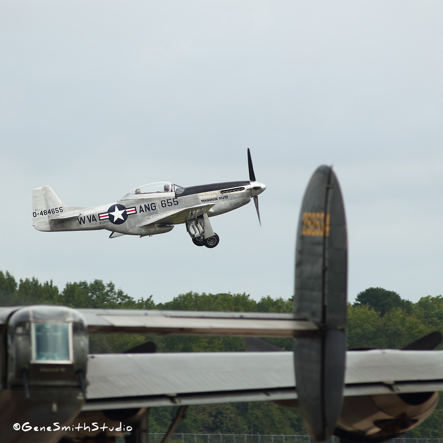 Silver P-51 Mustang takes off in an airshow in Cape May, New Jersey.