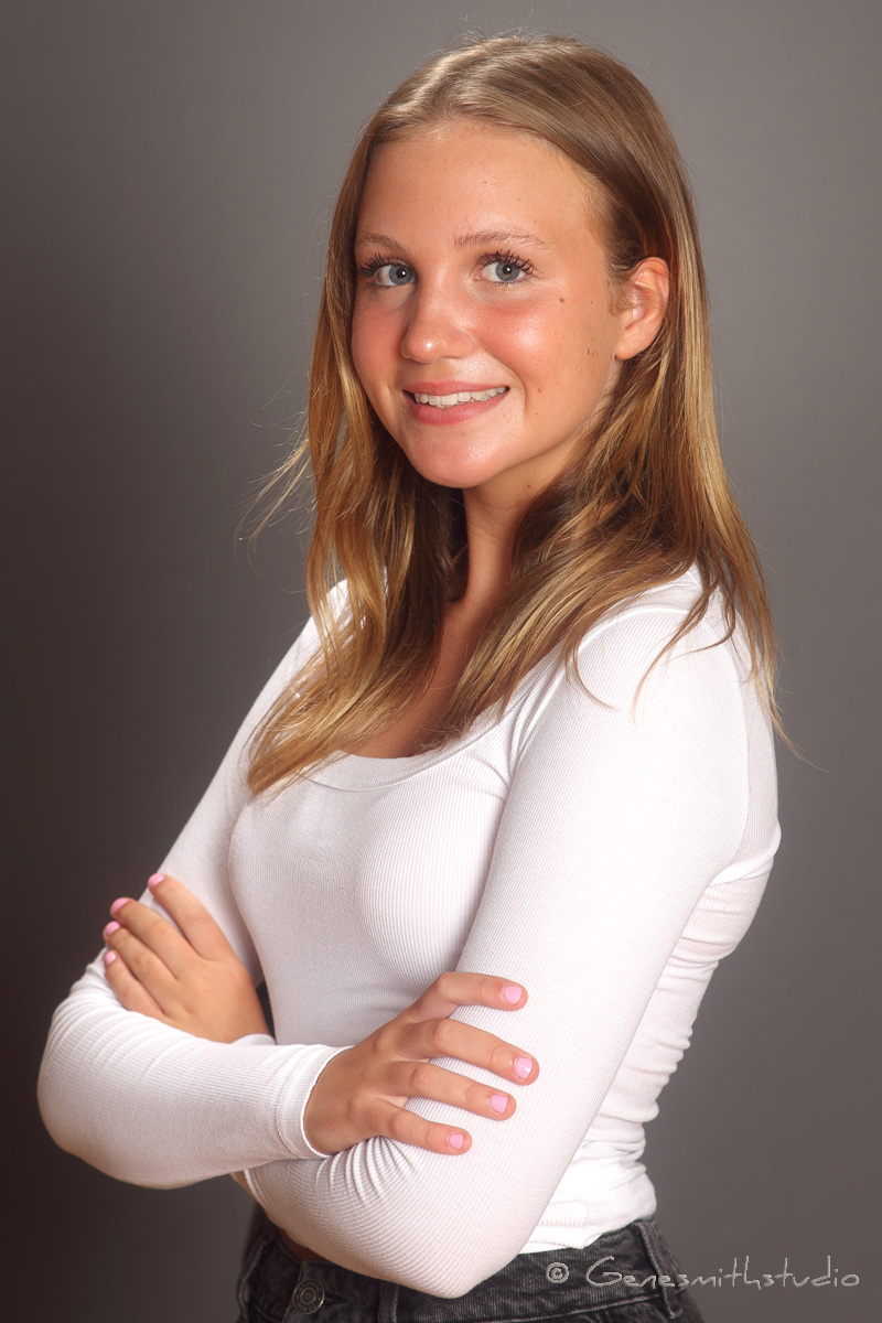 Attractive young blonde woman poses for head shot.